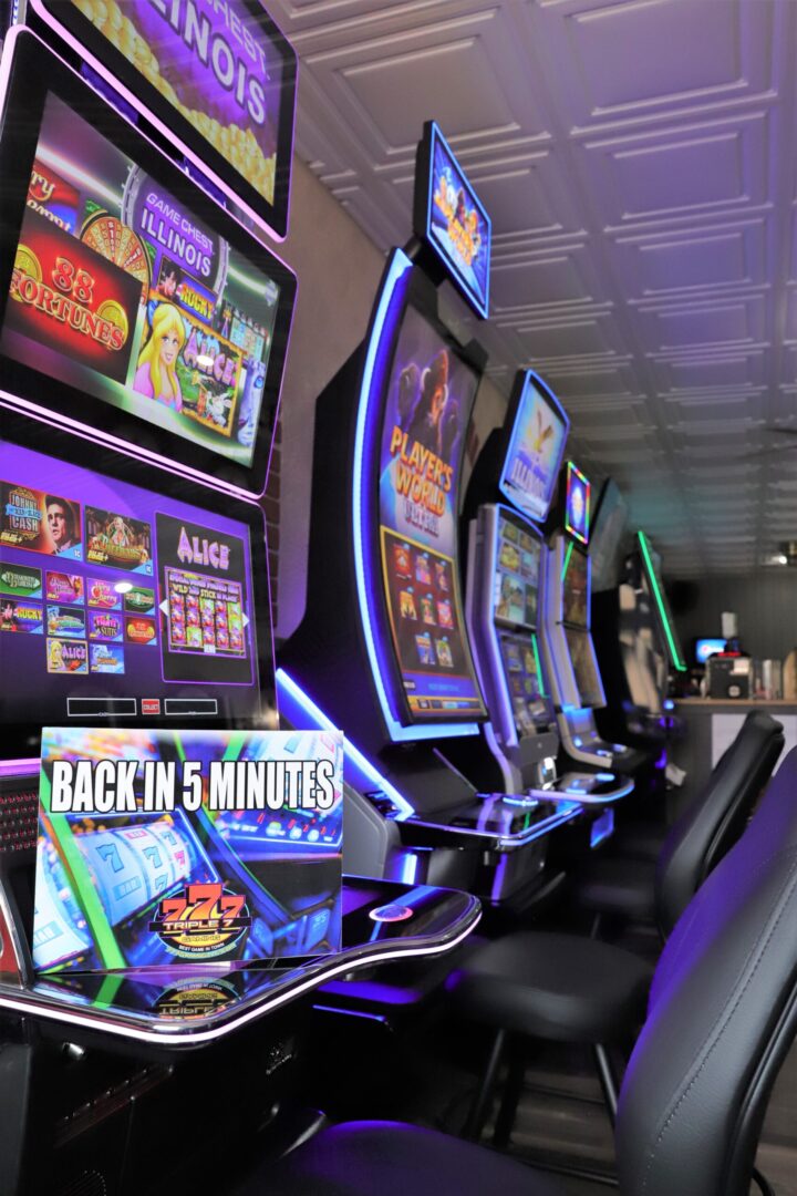 A row of slot machines in a room.